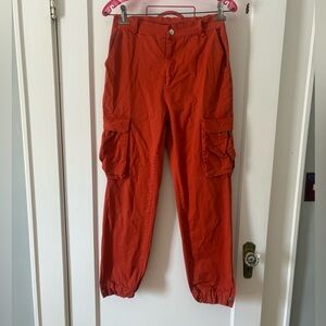 Orange high waisted cargo pants cuffed by Celebrity Fashion Hera Collection M